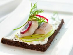 Бутерброды с маслом и сельдью на черном хлебе