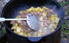 Картофель с тушенкой в кастрюле на костре
